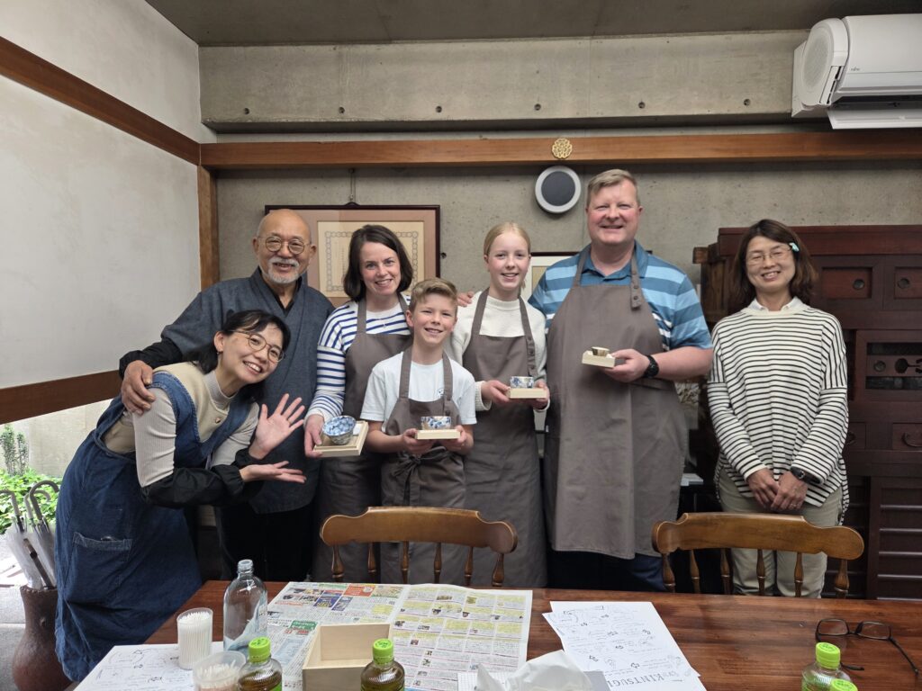 Guests participating in a Kintsugi workshop, repairing broken pottery with lacquer and gold using a traditional Japanese technique.