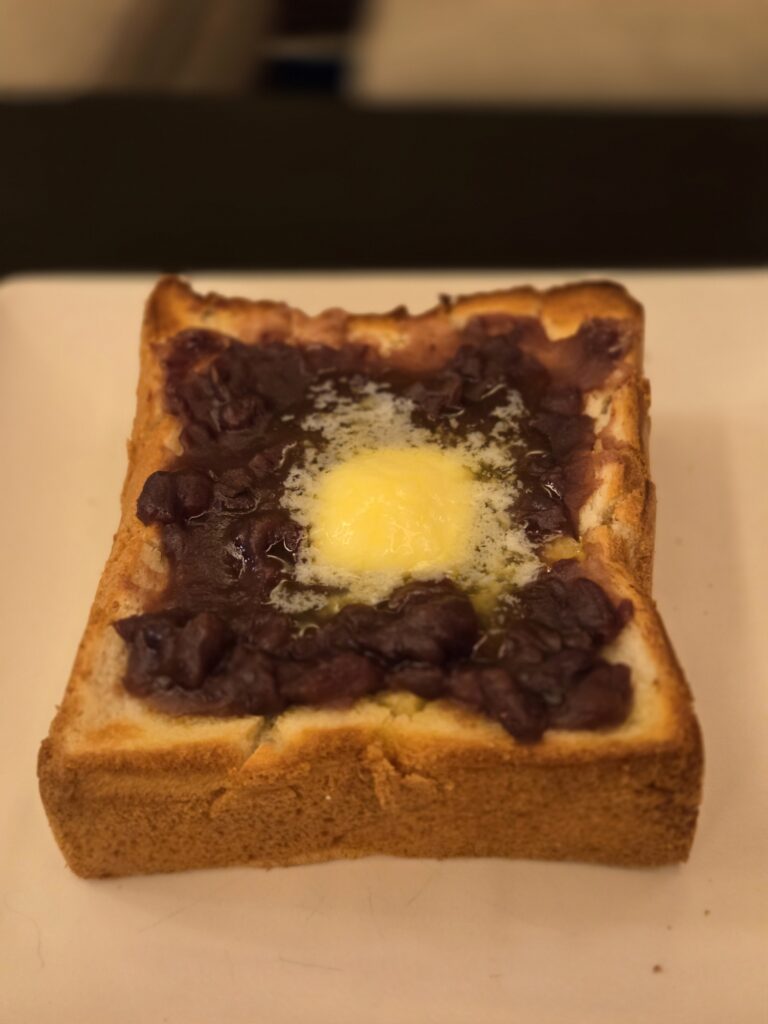 An butter toast served at Cafe Fugetsu in Gion, featuring thick-cut toasted bread topped with sweet red bean paste and melting butter. A classic Japanese-style café combination of sweet anko and rich butter.