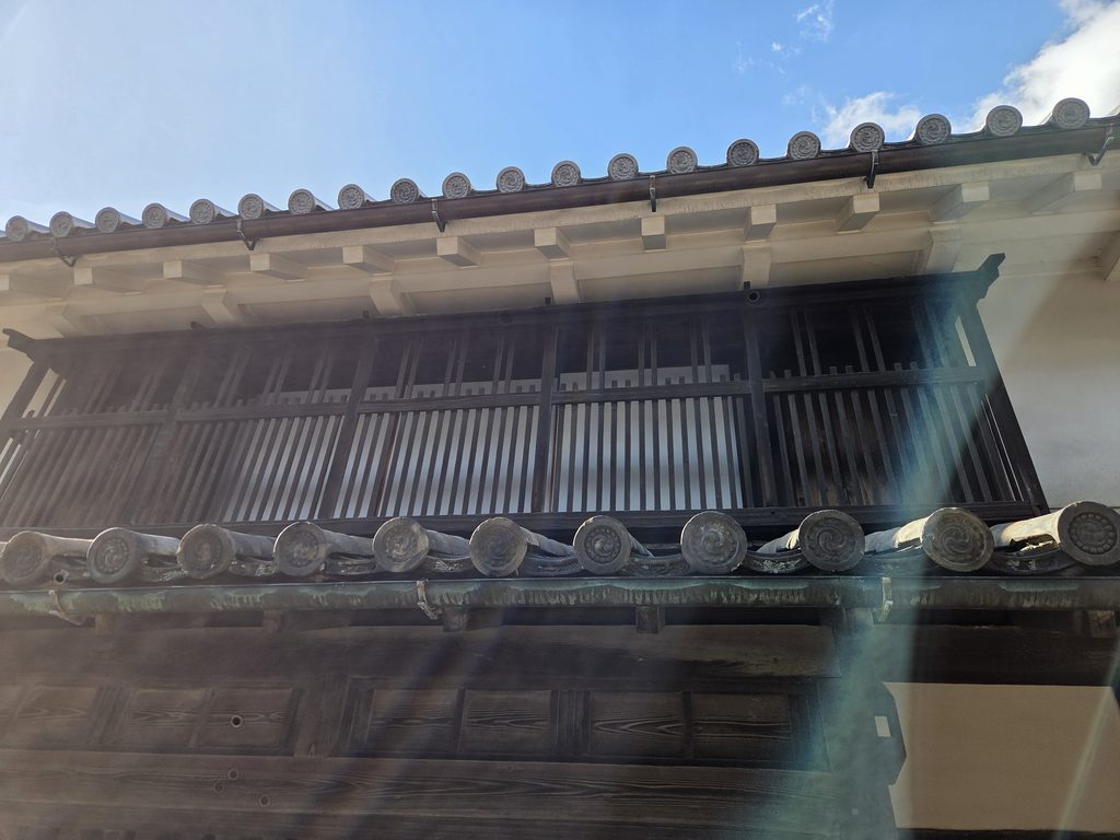 Traditional machiya facade with wooden latticework and tiled eaves in Imai-cho, Kashihara, Nara