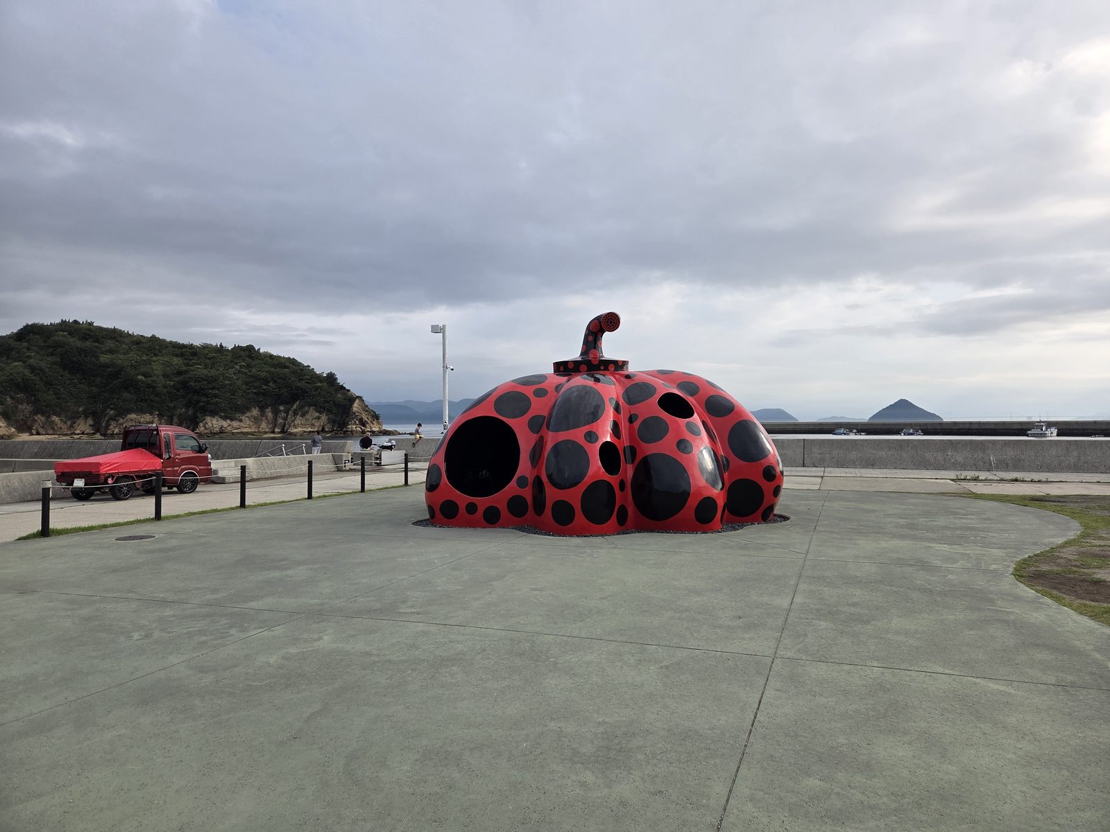 Yayoi Kusama’s red and black polka-dot pumpkin sculpture by the sea on Naoshima Island