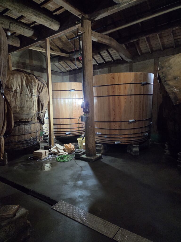 Traditional wooden fermentation barrels at Mizuho Vinegar Brewery in Nara, Japan