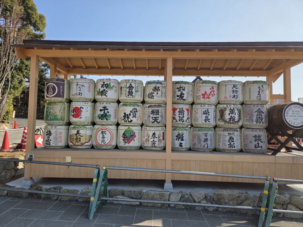 Decorative sake barrels offered by sake breweries at Omiwa Shrine in Nara