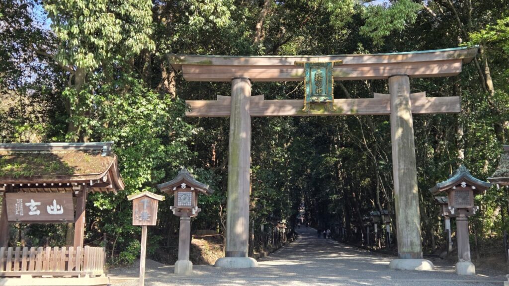 Torii gate and forest approach of Omiwa Shrine in Nara, with the Miwa Myojin plaque
